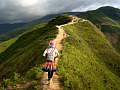 person walking alone on a mountainous path